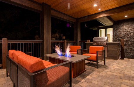 Covered paver deck with firepit in The Reserve